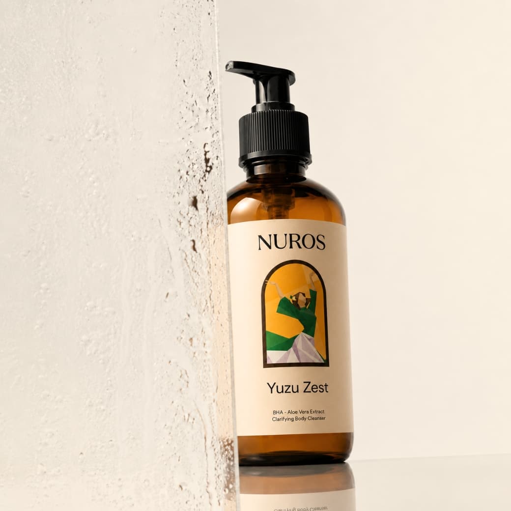 NUROS Yuzu Zest bottle beside a wet textured wall